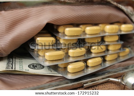 Contents female bags. Things from open bag. Yellow tablets, vitamins, dietary supplement.