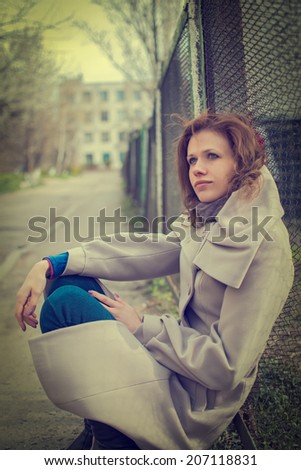 Portrait of beautiful young dreaming woman out-of-doors