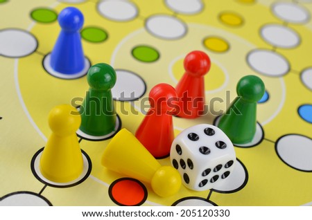 Colored board game figures with dice