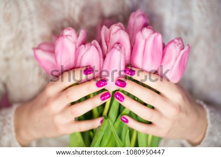 woman nails, manicure with flowers. Nails covered with nail polish.