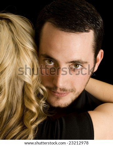 Couple hugging done in stylized warm tones. Man\'s face is visible, with woman\'s blond hair up against his face.