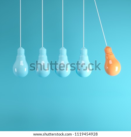 Hanging light bulbs with glowing one different idea on light blue background , Minimal concept idea