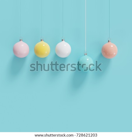 Color full christmas ball Ornaments hanging on blue background. minimal christmas concept.