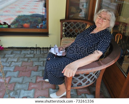 Happy old lady writing a letter