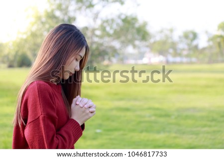 Woman praying in the morning. Woman praying on nature background. Women praying to god.