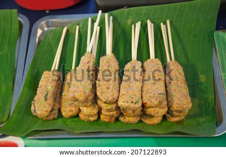 close up delicious of curried fish patties or grill meat  fish patty inside banana leaf in culture market at Thailand