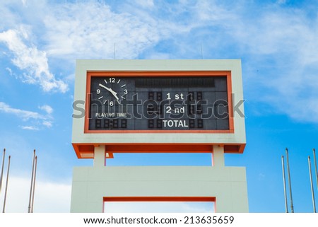 score board at football stadium on blue sky
