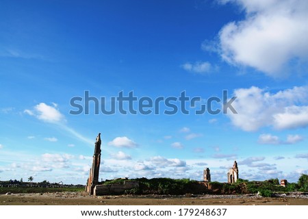 Fallen wall on the beach and blue sky background