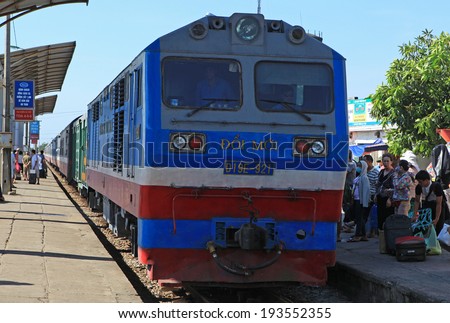 NGHE AN, VIETNAM - MAY 18, 2014: Passengers preparing to catch a diesel engine train at Vinh railway station to get to Hanoi capital. The train is slow and noisy but more safe than other vehicles.