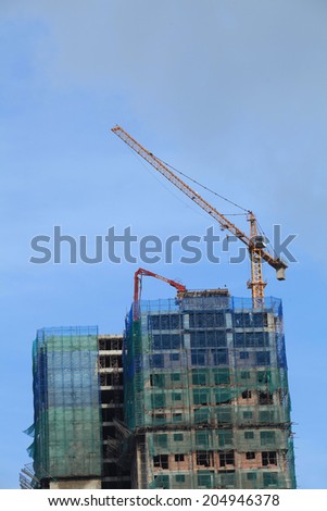 HANOI, VIETNAM - JUL 14, 2014: A new building under construction in a new suburb area of Hanoi capital. Home and office construction have been rising in Vietnam as a developing country.