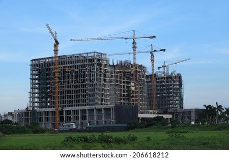 HANOI, VIETNAM - JUL 14, 2014: A new building under construction in a new suburb area of Hanoi capital. Home and office construction have been rising in Vietnam as a developing country.