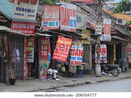 HANOI, VIETNAM - JUL 12, 2014: Panels of advertising for retail services and commodity products as small business is very popular in Hanoi capital.
