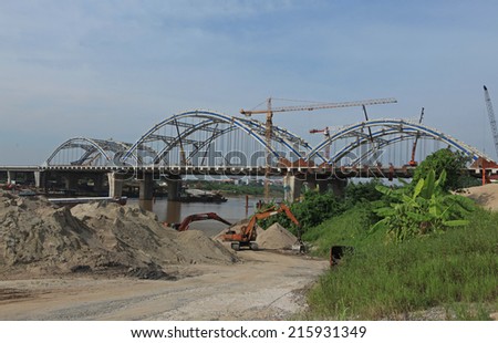 HANOI, VIETNAM - SEP 7, 2014: An under construction bridge connecting the two parts of Red river in Hanoi capital.