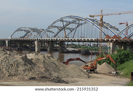 HANOI, VIETNAM - SEP 7, 2014: An under construction bridge connecting the two parts of Red river in Hanoi capital.