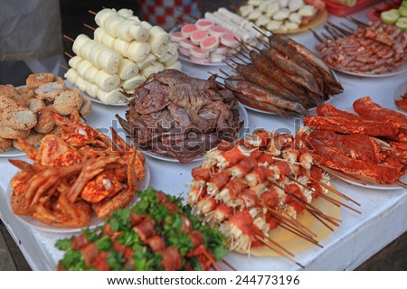 Street food in Vietnam, typical style of dining on street side in Vietnam. Focus on the center.