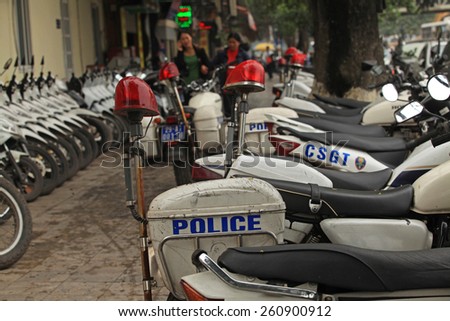 Hanoi, Vietnam - Mar 15, 2015: Vietnamese traffic police motorcycles parking on the sidewalk of a street in Hanoi.