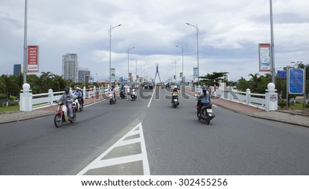 Da Nang, Vietnam - Jul 21, 2015: Many motorbikes traveling on Song Han bridge to the center of Da Nang city on a usual day. Da Nang is the biggest city in central Vietnam.