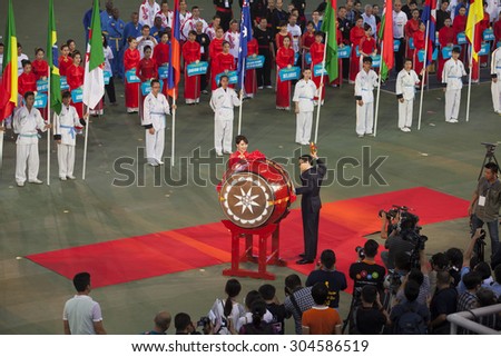 Hanoi, Vietnam - Aug 9, 2015: Deputy Prime Minister of Vietnam Government Vu Duc Dam making a range of drum as procedure of opening ceremony of Vietnam Vocotruyen International Champion.