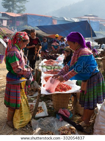 LAO CAI, VIETNAM - OCT 17, 2015: Hmong tribe people selling chili pepper and other agriculture products at Can Cau flea market. Flea market is very popular as one kind of small business in Vietnam.