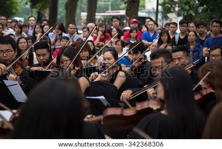 Hanoi, Vietnam - Nov 22, 2015: An outdoor live classic concert music by Asian composers performing on the side walk of an old quarter street in Hanoi capital city.