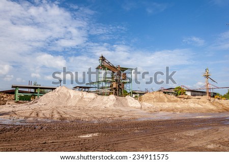 Industrial background - crusher (rock stone crushing machine) at open pit mining and processing plant for crushed stone, sand and gravel