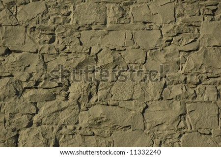 Cream painted angular cemented stone wall background