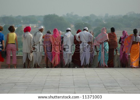 Crowd of Indian tourists looking over wall at Taj Mahal, Agra, India