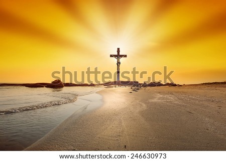 The cross at sunset on the beach background.