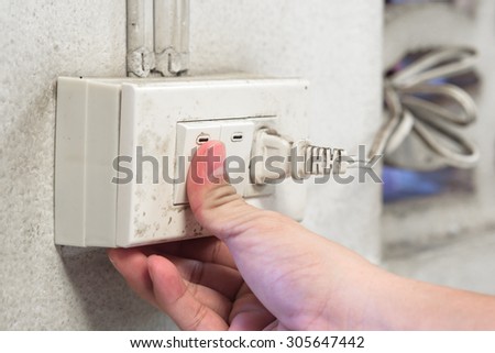Finger pressing old light switch