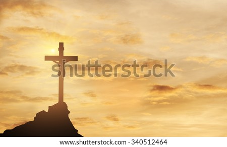 Silhouette Jesus and the cross over sunset on mountain top