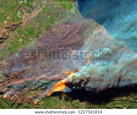 Wildfire Camp burns out from aerial above in California. Fire and smoke. Forest fire. Black smoke and orange fire view from space. California Camp wildfire. Satellite view California USA.