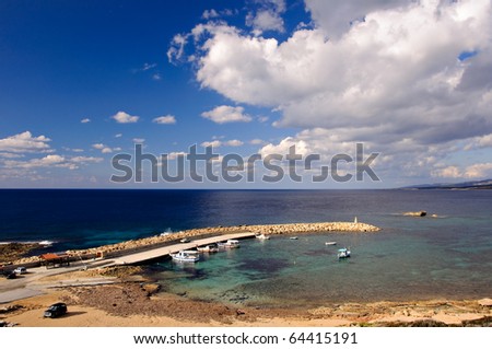 Small harbor with fishing boats inside it