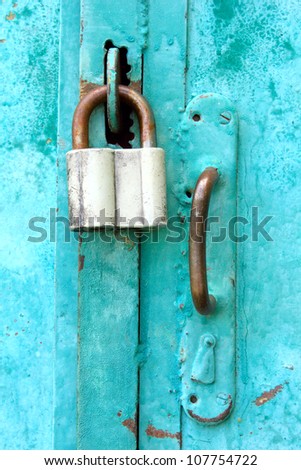 The padlock locking the wooden door