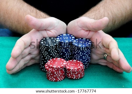 All in. Hands pushing all the chips into the center of the table