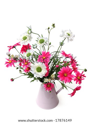 silk flowers in a pink jug