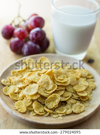 sugar-coated corn flakes with milk and grape background