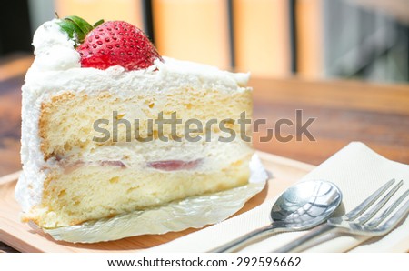 strawberry shortcake with spoon and fork, selective focus point on strawberry