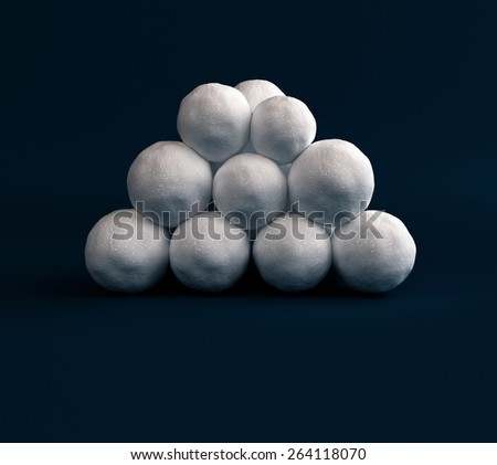 Snow balls stacked in a pile on a dark blue background, to play in the Snowball