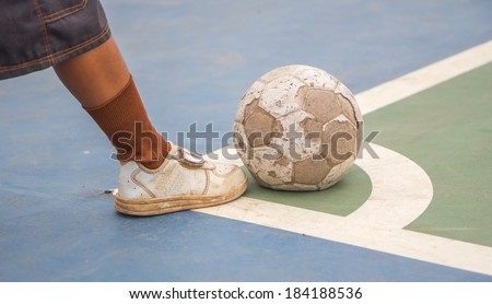 Boy is holding a football,old football,old shoe
