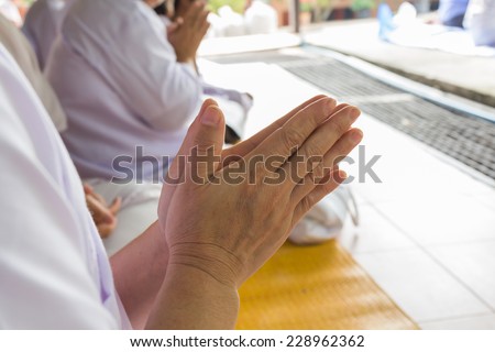 hands clasped in a prayer