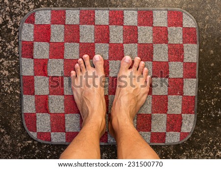 bare feet on doormat,dirty floor