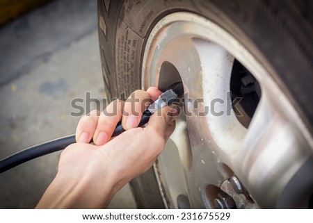 Hand checking tyre pressure