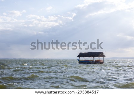 boat on the open blue sea at the sunset.