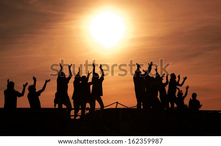 People partying at sunset.