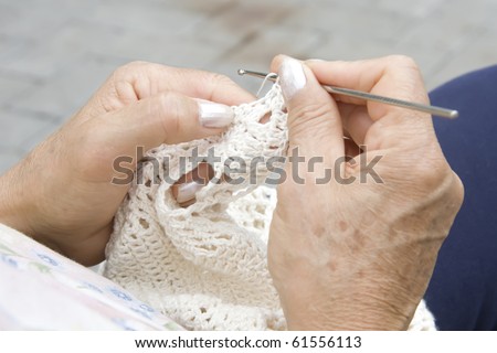 hands knitting in a square