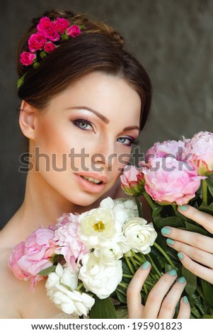 Portrait of Beautiful Young Woman in Flowers. Healthy Long Hair And Clean Skin