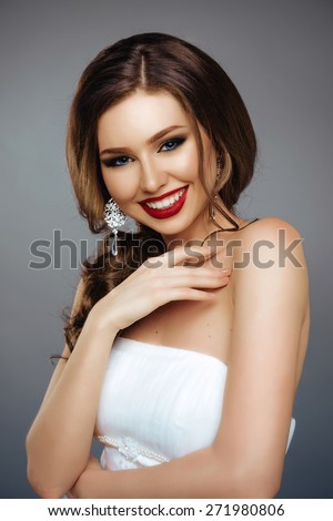 Portrait of Beautiful Smiling Woman with Long Hair, Fashion MakeUp and Red Lips. Close Up