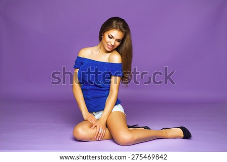 Portrait of Young Beautiful Smiling Woman in White Jeans Shorts and Blue Blouse. Long Hair, Fashion MakeUp and Pink Lips