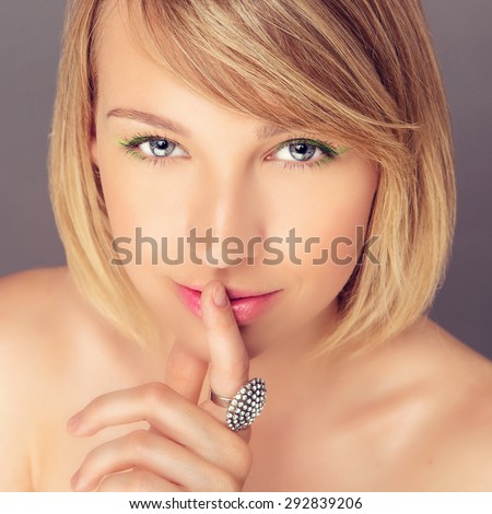 Portrait of Beautiful Young Mysterious Woman with Short Blond Hair and a Diamond Ring. Close Up