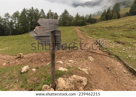 wooden board with directions in Dolomites, Italy